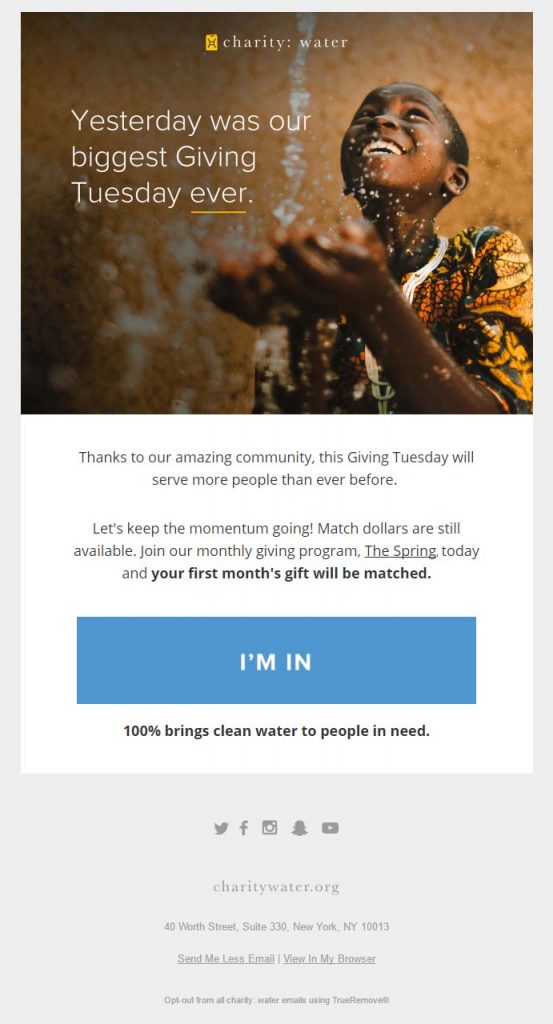 charity: water's Giving Tuesday email campaign featuring a smiling African boy cupping a stream of clean water with his hands